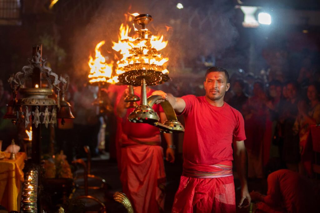 nepalese priest performing evening arati premises basantapur durbar square 1